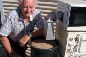 DAFWA researcher John Moore with the modified microwave. (Photo supplied by DAFWA)
